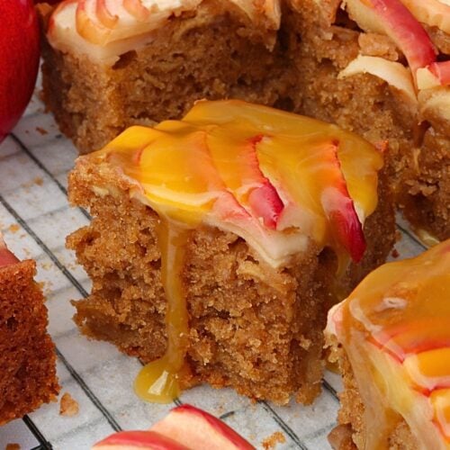 caramel apple cake - Cakes by MK Slices of apple spice cake with caramel drizzle and apple slices on top, close-up on a cooling rack